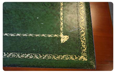 Re-leathered desktop detail showing gold lining